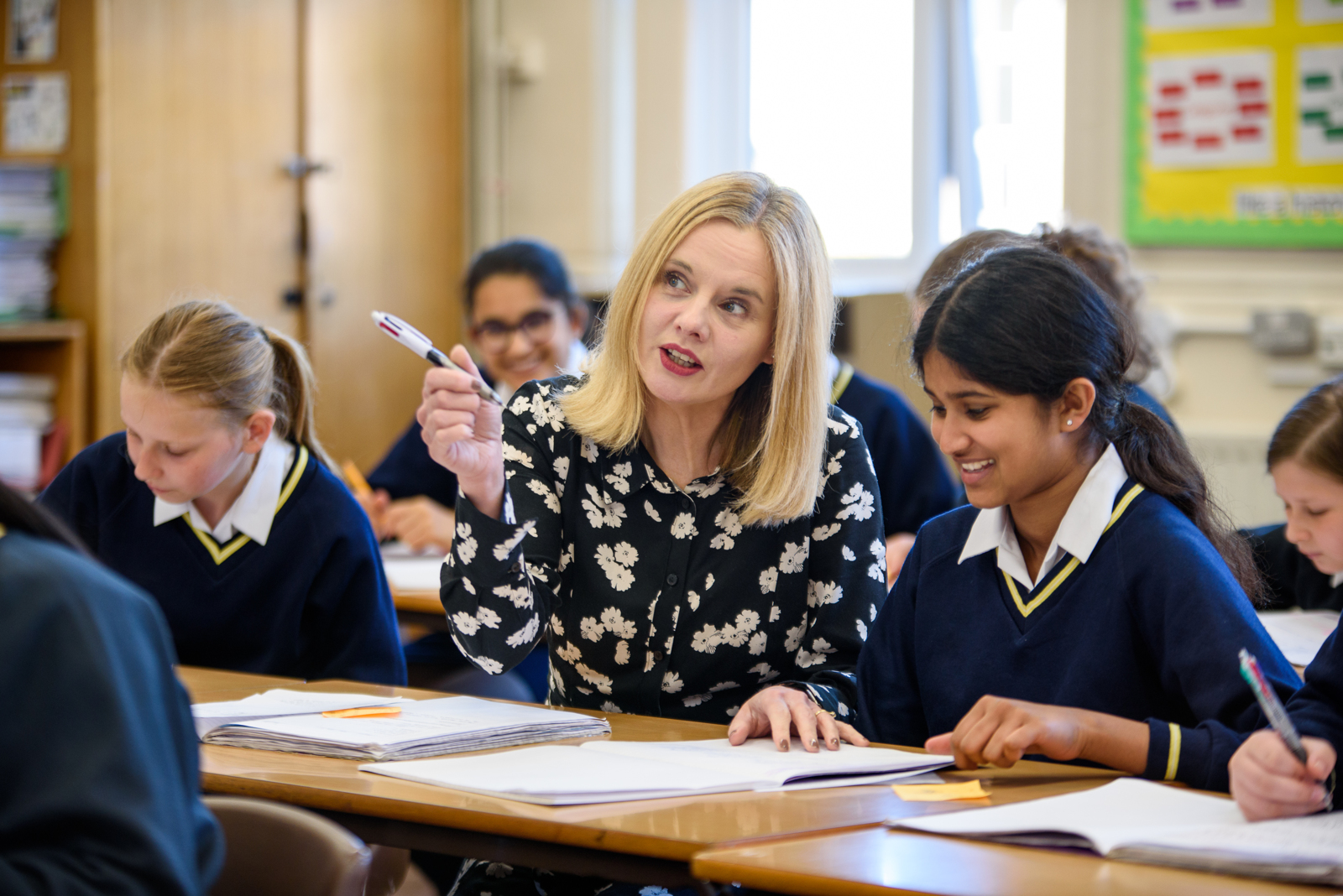 Teacher with pupil in classroom